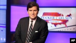 FILE - Tucker Carlson poses in a Fox News Channel studio in New York, March 2, 2017. Fox took Carlson off the air last month; on Tuesday he said he would relaunch his show on Twitter "soon."