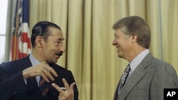 FILE - President Jimmy Carter with Jorge R. Videla, president of Argentina, at the White House, Sept. 9, 1977.
