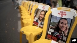 FILE - A poster of Noa Argamani is taped to one of the empty chairs for hostages held by Hamas in the Gaza Strip as relatives and their supporters gather together to call for an immediate deal to release their loved ones, in Jerusalem, May 10, 2024.