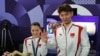 Chinese badminton mixed doubles gold medalist Huang Yaqiong shows off her engagement ring after teammate Liu Yuchen proposed to her at the medal ceremony on Aug. 2, 2024, in Paris.