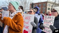 FILE - Advocates for transgender youth rally outside the New Hampshire Statehouse, in Concord, N.H., March 7, 2023.