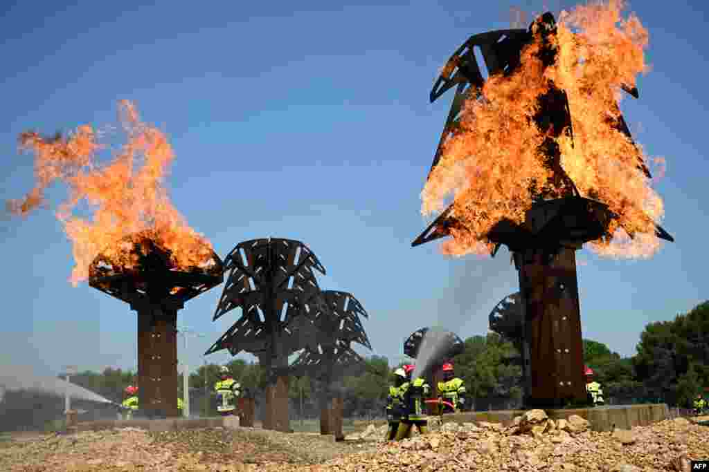 Firefighter recruits complete their training at the fire brigade of the Bouches-du-Rhone department training center in Velaux, southern France.