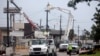 FILE - Utility crews work to restore electricity in Houston, Texas, July 11, 2024. As of July 18, most Houston residents finally had electricity after more than a week of widespread outages caused by Hurricane Beryl.