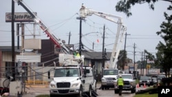 FILE - Utility crews work to restore electricity in Houston, Texas, July 11, 2024. As of July 18, most Houston residents finally had electricity after more than a week of widespread outages caused by Hurricane Beryl.