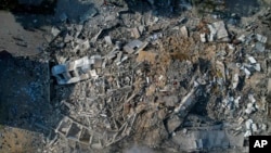 FILE - A view of the rubble of a building after it was struck by an Israeli airstrike, in Gaza City, on Oct. 8, 2023.