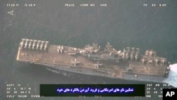 This image provided by the Iranian Revolutionary Guard via Tasnim News Agency on Aug. 20, 2023, shows the USS Bataan at the Strait of Hormuz.