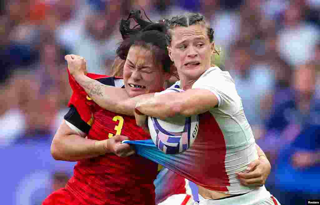 Lou Noel of France, right, is tackled by Qi Su of China, left, during the women&#39;s placing 5-6 Rugby Sevens match between China and France at the 2024 Summer Olympics in the Stade de France.