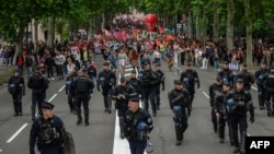 Anti-riot police officers walk ahead of an anti far-right rally in Toulouse after French president called legislative elections following far-right parties' gains in European Parliament elections, June 15, 2024.