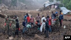 FILE - In this photo taken on March 17, 2023, Malawi Defense Force soldiers and civilians work to recover body of a victim of a mudslide from heavy rains after Cyclone Freddy during a rescue operation in Blantyre, Malawi.