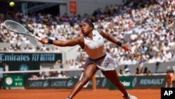 FILE - Coco Gauff plays a shot against Poland's Iga Swiatek during their semifinal match of the French Open tennis tournament at the Roland Garros stadium in Paris, June 6, 2024. Gauff will join LeBron James as a flag bearer for the US Olympic team at Friday's opening ceremony.