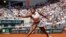 FILE - Coco Gauff plays a shot against Poland's Iga Swiatek during their semifinal match of the French Open tennis tournament at the Roland Garros stadium in Paris, June 6, 2024. Gauff will join LeBron James as a flag bearer for the US Olympic team at Friday's opening ceremony.