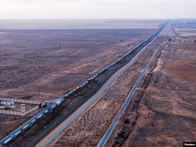 A drone picture of a line of trucks waiting on an Egyptian road along the border with Israel, near the Rafah border crossing with the Gaza Strip, May 2, 2024.