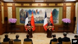 Chinese Foreign Minister Wang Yi, right, and French Foreign Minister Stephane Sejourne, left, attend a joint press conference at the Diaoyutai State Guesthouse in Beijing, April 1, 2024. 