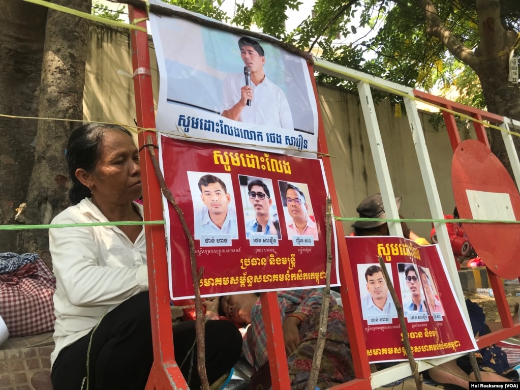 ផ្ទាំងរូបភាពទាមទារឱ្យអាជ្ញាធរដោះលែងលោក ថេង សាវឿន ប្រធានសមាគមសម្ព័ន្ធសហគមន៍កសិករកម្ពុជា (CCFC) និងសហការីរបស់លោក២នាក់ទៀត នៅទីក្រុងភ្នំពេញ កាលពីថ្ងៃទី២២ ខែឧសភា ឆ្នាំ២០២៣។ (ហ៊ុល រស្មី/វីអូអេ)