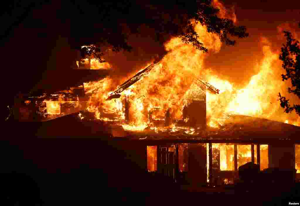 A burning house is seen as Park Fire burns near Chico, California.