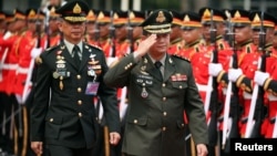 FILE - Thailand's Royal Army Chief General Apirat Kongsompong and Cambodia's Army Chief General Hun Manet review the honour guards during the welcome ceremony at the Thai Army headquarters in Bangkok, Thailand, April 2, 2019. 