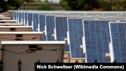 FILE - Solar cell panels set up on the West Campus of Arizona State University in Phoenix, Arizona.