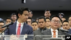 FILE - Move Forward party leader Chaithawat Tulathon, right, flanked by its former leader Pita Limjaroenrat, talks to reporters during a news conference at parliament in Bangkok, Thailand, on Jan. 31, 2024.