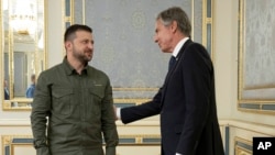 Ukraine's President Volodymyr Zelenskyy greets U.S. Secretary of State Antony Blinken before their meeting at the Presidential Office in Kyiv, Sept. 6, 2023. 