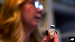 Becky Hormuth holds a vial of testosterone Sept. 20, 2023, in Wentzville, Mo.