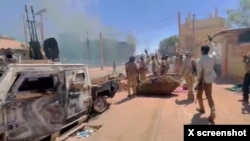 RSF fighters stand near the damaged Air Defence Forces command center in Khartoum, Sudan, May 17, 2023, in this screen grab obtained from a social media video. (RSF via Twitter/via Reuters)