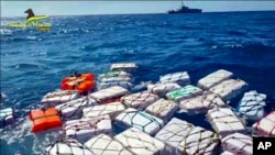 Boxes containing cocaine float in the Sicilian Strait off Catania in this picture made available by the Italian Financial Police on April 17, 2023. 