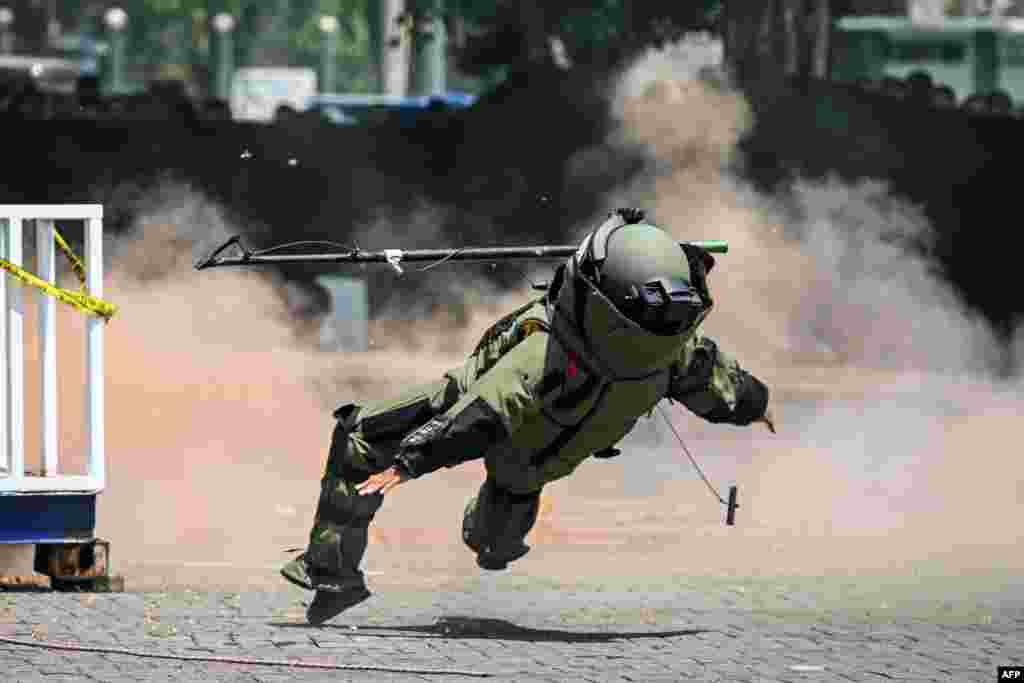 A police officer from an explosive disposal unit takes part in a security drill ahead of next year's general election in Sidoarjo, East Java.