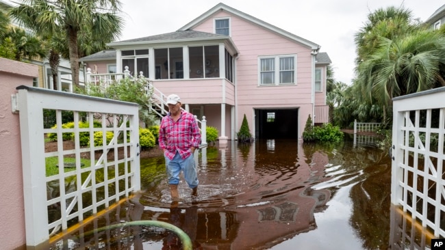 Robert Chesnut walks through water at his Palm Blvd. home after it was flooded by Tropical Storm Debby, Aug. 8, 2024, in Isle of Palms, South Carolina.