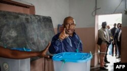 Incumbent Comoros President and presidential candidate for the Convention for the Renewal of the Comoros (CRC) party, Azali Assoumani, gestures after casting his ballot at the Mitsudje public school polling station in Moroni on January 14, 2024. 