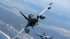 FILE - A Romanian Air Force F-16 military fighter jet, left, and a Portuguese Air Force F-16 military fighter jets participating in NATO's Baltic Air Policing Mission operate over the Baltic Sea, on May 22, 2023. 