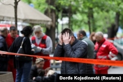 People react after a 14-year-old boy opened fire on other students and security guards at a school in downtown Belgrade, Serbia, May 3, 2023.