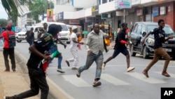 Anti-government demonstrators run after riot police officers fired a tear gas to disperse them during a peaceful protest along the streets of Mombasa, Kenya, July 23, 2024.