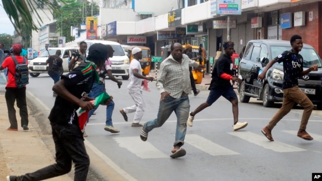 Anti-government demonstrators run after riot police officers fired a tear gas to disperse them during a peaceful protest along the streets of Mombasa, Kenya, July 23, 2024.