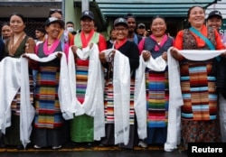 Women from the Sherpa community wait to welcome Kami Rita Sherpa, 53, a Nepali mountaineer, after he climbed Mount Everest for the 28th time, in Kathmandu, Nepal May 25, 2023.