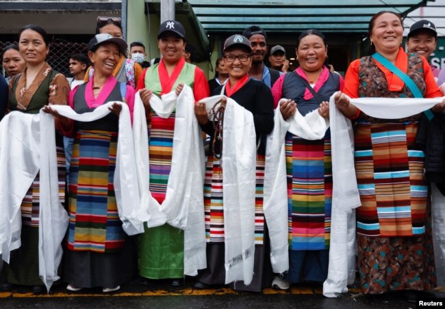 Women from the Sherpa community wait to welcome Kami Rita Sherpa, 53, a Nepali mountaineer, after he climbed Mount Everest for the 28th time, in Kathmandu, Nepal May 25, 2023.