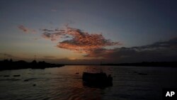 FILE - A passenger boat departs from the port city of Breves, located on the island of Marajo, Para state, on the mouth of the Amazon river, Brazil, Dec. 3, 2020.