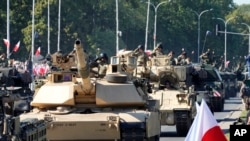 FILE - U.S.-made Abrams tanks purchased by Poland take part in a military parade in Warsaw, Poland, Aug. 15, 2023. The U.S. military has said all 31 Abrams tanks promised to Ukraine have been delivered as of Oct. 16, 2023.