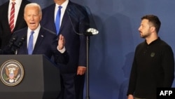 Ukraine's President Volodymyr Zelenskyy, right, listens as US President Joe Biden, center, speaks during the closing of the NATO 75th anniversary summit at the Walter E. Washington Convention Center in Washington, July 11, 2024. (Stefan Rousseau /Pool/AFP)