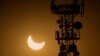 FILE - A cell phone tower is seen during a partial solar eclipse in Rawalpindi, Pakistan, Oct. 25, 2022. Internet services were slowed in country on Sunday and access to major social media platforms blocked during a rare online opposition rally.