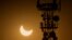 FILE - A cell phone tower is seen during a partial solar eclipse in Rawalpindi, Pakistan, Oct. 25, 2022. Internet services were slowed in country on Sunday and access to major social media platforms blocked during a rare online opposition rally.