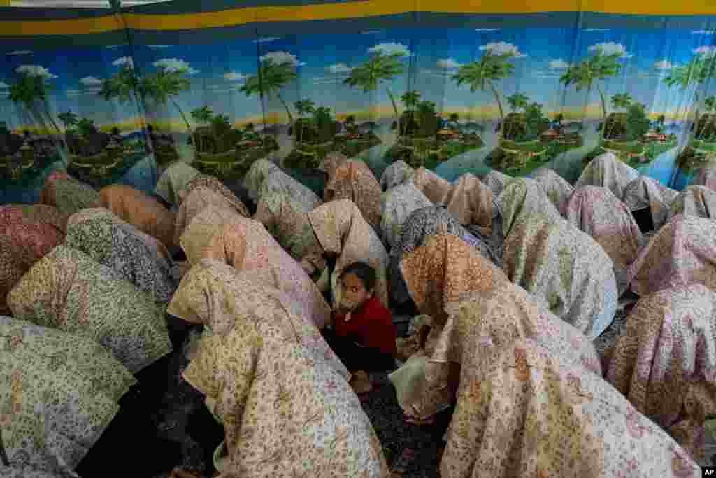 A girl sits among Kashmiri Muslim brides during a mass wedding event in Srinagar, Indian-controlled Kashmir, Sept. 10, 2023.