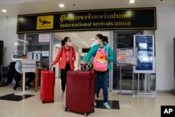 FILE - Chinese tourists arrive at Chiang Mai international airport in Chiang Mai province, northern Thailand, Jan. 23, 2023.