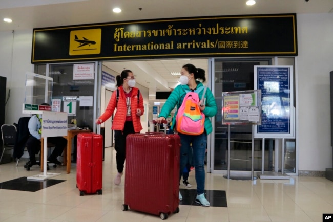 FILE - Chinese tourists arrive at Chiang Mai international airport in Chiang Mai province, northern Thailand, Jan. 23, 2023.
