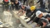 In this photo provided by the National Police of Ukraine, emergency services and policemen work to save an injured police officer from under the rubble following a Russian attack in Kryvyi Rih, Ukraine, Sept. 8, 2023. 