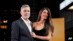 FILE - Oscar-winning actor and filmmaker George Clooney and his wife, human rights lawyer Amal Clooney, arrive at a film screening in London, Dec. 3, 2023.