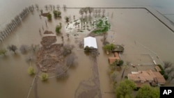 A home sits in rising floodwaters after a levee break caused extensive flooding around Corcoran, Calif., on Tuesday, March 21, 2023. (Carlos Avila Gonzalez/San Francisco Chronicle via AP, File)