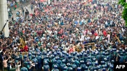 Students scuffle with police during a protest to demand merit-based system for civil service jobs in Dhaka, Bangladesh.