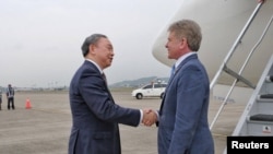 FILE - Taiwanese Vice Minister of Foreign Affairs Alexander Tah-ray Yui shakes hands with Michael McCaul, the chairman of the U.S. House Foreign Affairs Committee, at an airport in Taiwan in this handout released April 6, 2023. 