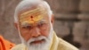 FILE- Indian Prime Minister Narendra Modi has sandalwood paste and vermilion applied on his forehead during the inauguration of Kashi Vishwanath Dham Corridor in Varanasi, India, Dec. 13, 2021. 