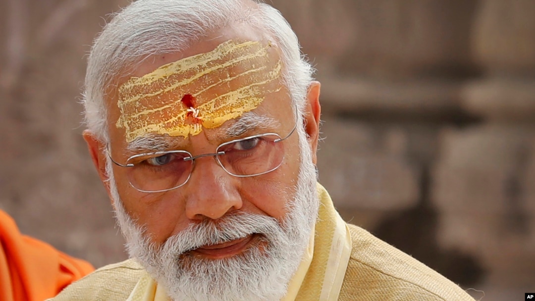 FILE- Indian Prime Minister Narendra Modi has sandalwood paste and vermilion applied on his forehead during the inauguration of Kashi Vishwanath Dham Corridor in Varanasi, India, Dec. 13, 2021. 